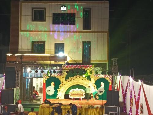 a stage in front of a building with christmas lights at Hotel Swastik Bhumi & Restaurant in Gaya