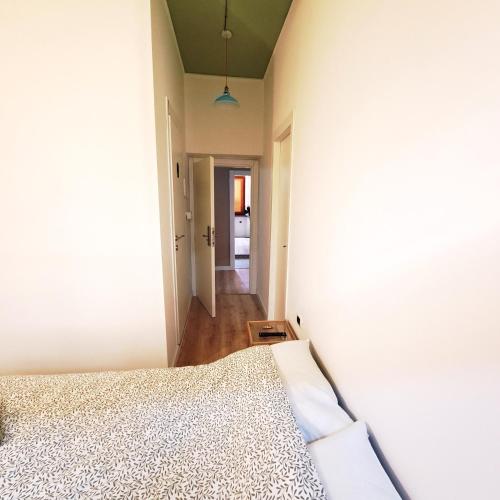 a bedroom with a bed and a hallway at daClaudia,it a piedi 5 min dalla stazione, 10 min dal centro in Spoleto