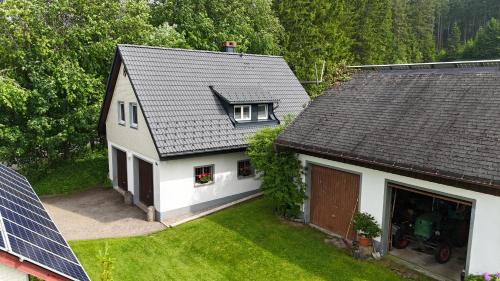 an overhead view of a white house with a roof at Ferienwohnung Schwarzwaldhof in Titisee-Neustadt