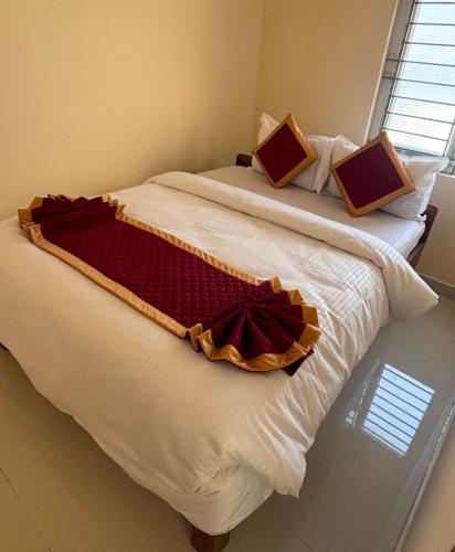 a bedroom with two beds with white sheets and a window at Vinttage park hotels in Bengaluru
