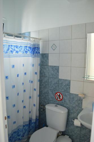 a bathroom with a toilet and a sink at Karyatides Houses in Kariá
