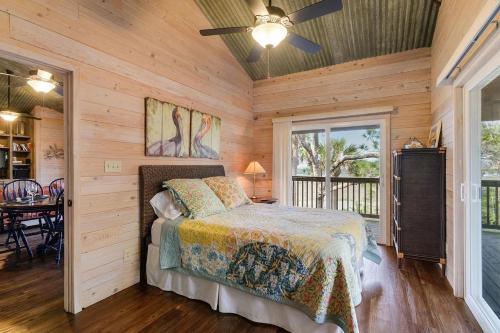 a bedroom with a bed in a wooden room at 1 Old House Cay - Private Island Oasis in Hilton Head Island