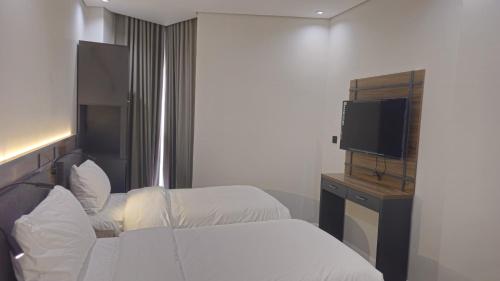 Ένα ή περισσότερα κρεβάτια σε δωμάτιο στο Samama Ajyad Hotel Makkah