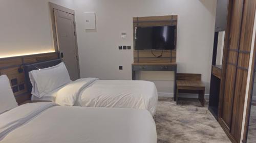 Ένα ή περισσότερα κρεβάτια σε δωμάτιο στο Samama Ajyad Hotel Makkah