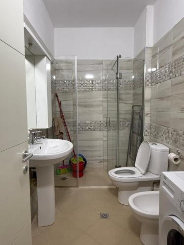 a bathroom with a toilet and a sink and a shower at Sani Apartment in Golem