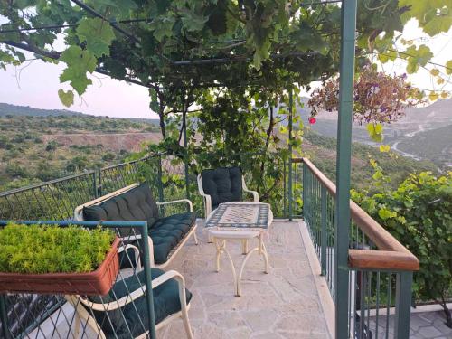 a balcony with chairs and a table and a view at Apartments "Old house Mustafic" in Bar