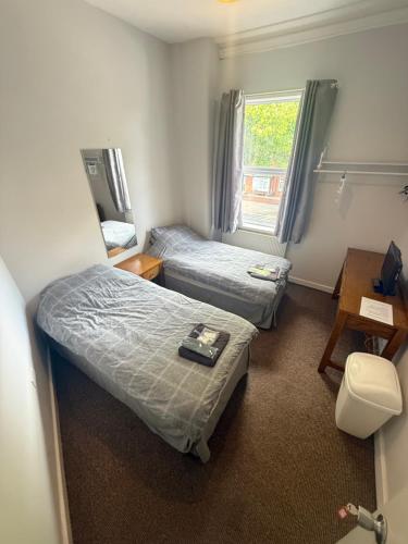 a room with two beds and a window at St Georges Hotel in Hull