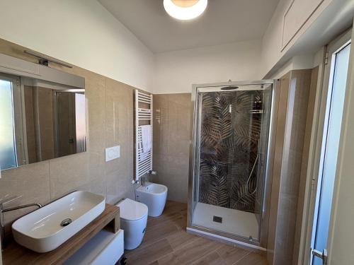 a bathroom with a sink and a toilet and a shower at Saint Peter's Sunset View Luxury Apartment in Rome