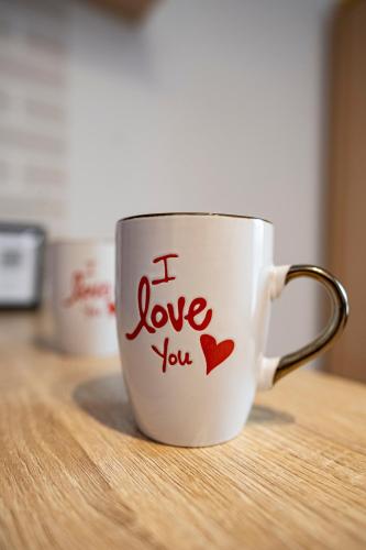 a coffee cup with the words i love you written on it at Cozy compact studio France in Saint-Louis