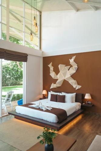 a bedroom with a large bed with stars on the wall at Mawella Beach Resort in Tangalle