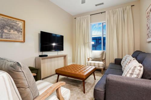 a living room with a couch and a tv at Unbeatable Location Golden Condo - Walk Everywhere in Golden
