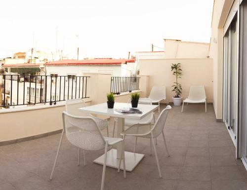 a patio with a table and chairs on a balcony at Soho Valencia in Valencia