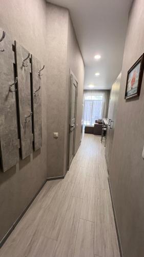 a hallway of a bathroom with two showers and a hallwayngth at VEM Apartment Калипсо in Odesa