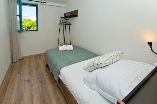 a bedroom with two twin beds and a window at Holiday Home Katia in Hvar