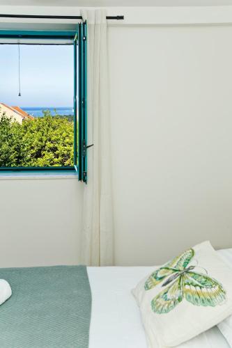 a bedroom with a window and a bed with a pillow at Holiday Home Katia in Hvar