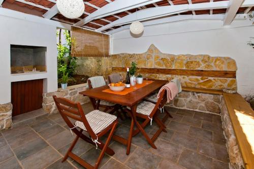 a patio with a wooden table and chairs at Holiday Home Katia in Hvar