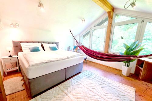 a hammock bed in a bedroom with a window at Ferienhaus Laufen in Laufen