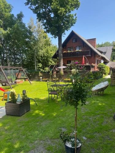 a yard with a house and a playground at Apartamenty i pokoje Domino Parking w cenie ! in Karpacz