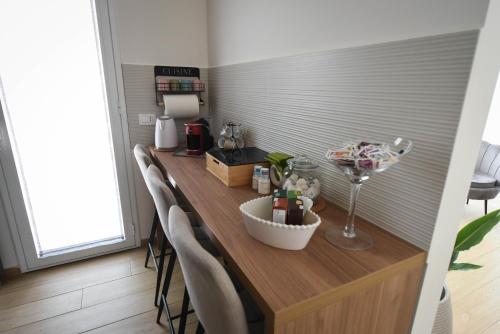 a kitchen with a counter with a bar with chairs at ETNAGLOW Luxory Sicilian Villa in Nicolosi