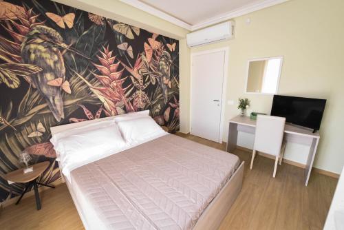a bedroom with a bed and a wall mural at ETNAGLOW Luxory Sicilian Villa in Nicolosi