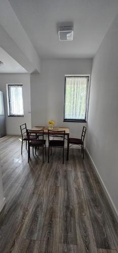an empty room with a table and chairs in it at Vera Home 3 in Râmnicu Vâlcea