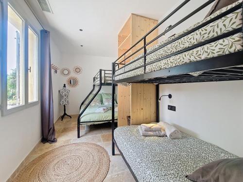 a bedroom with a bunk bed and a staircase at Villa tout équipée - Piscine & pool house - CLIM in Uzès
