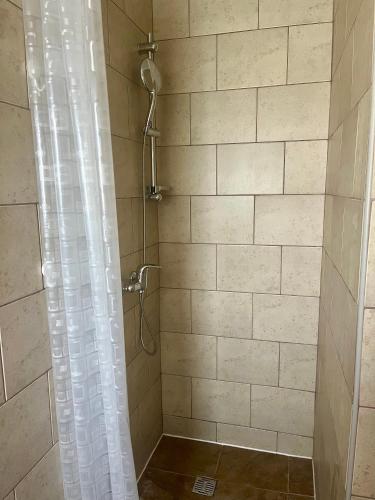 a shower with a shower curtain in a bathroom at Krišto Croatia in Kaštela