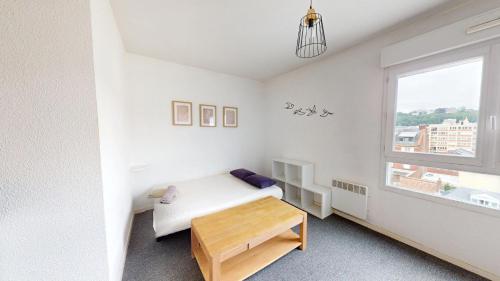 une chambre blanche avec un lit et une fenêtre dans l'établissement Bastion - Studio center with elevator, au Havre