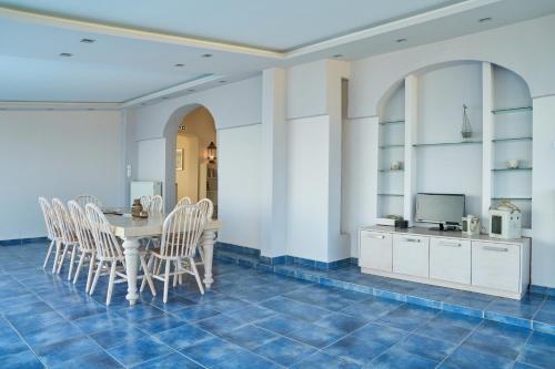 a dining room with a table and chairs at Grand Villa Maronia in Platanitis Rodopis
