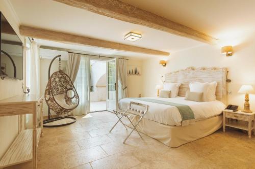 a bedroom with a large bed and a balcony at La Bastide des Salins in Saint-Tropez