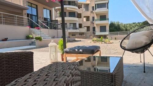 a patio with chairs and a table and a building at Dris Suites in Nikiana