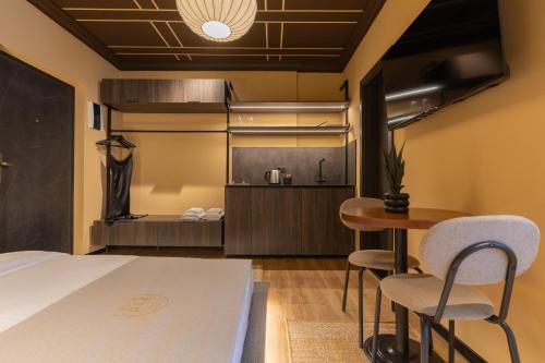 a bedroom with a bed and a table and chairs at Agara Stays Prizren in Prizren