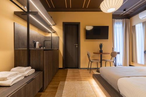 a hotel room with a bed and a table at Agara Stays Prizren in Prizren