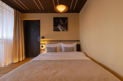a bedroom with a large bed with white pillows at Agara Stays Prizren in Prizren
