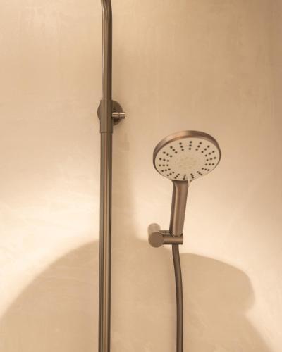 a shower head is attached to a wall at Agara Stays Prizren in Prizren