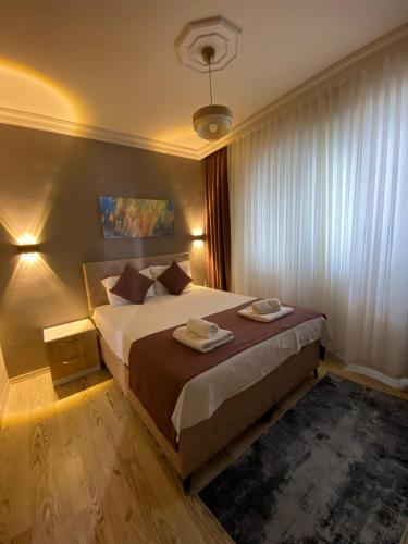a bedroom with a bed with two towels on it at Konyaalti Suite Hotel in Antalya