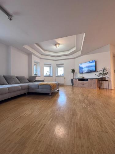 a living room with a couch and a flat screen tv at Rezidenca Vista Lux in Ptuj
