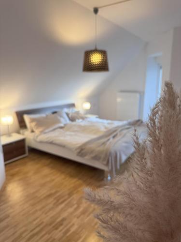 a bedroom with a bed and a pendant light at Rezidenca Vista Lux in Ptuj