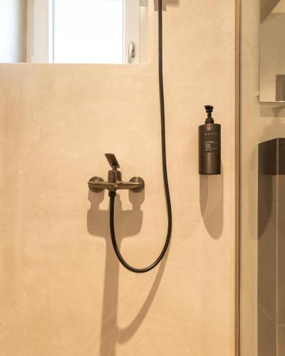 a shower with a soap dispenser on a wall at Agara Stays Prizren in Prizren