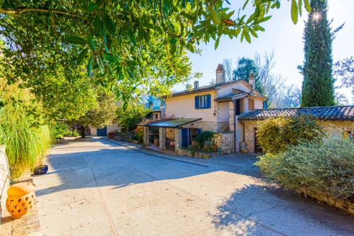 an empty street with a house and trees at Radius Horse Ranch B&B in Massa Martana