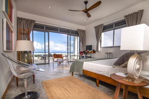 a bedroom with a bed and a view of the ocean at Villa Mustique - Perfect tropical paradise in El Limón
