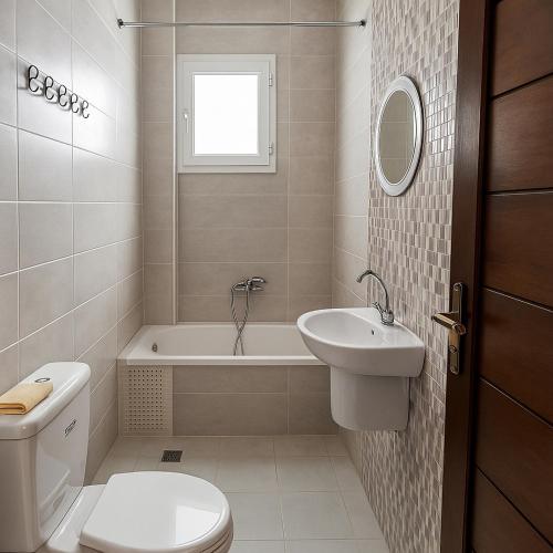 a bathroom with a toilet and a sink and a bath tub at Residence Amira in Monastir