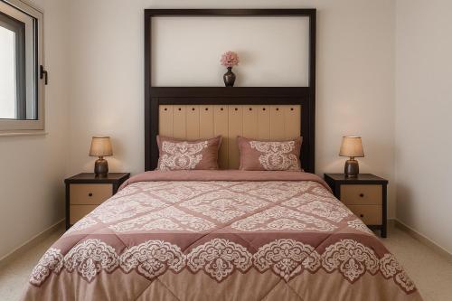 a bedroom with a large bed with two night stands at Residence Amira in Monastir