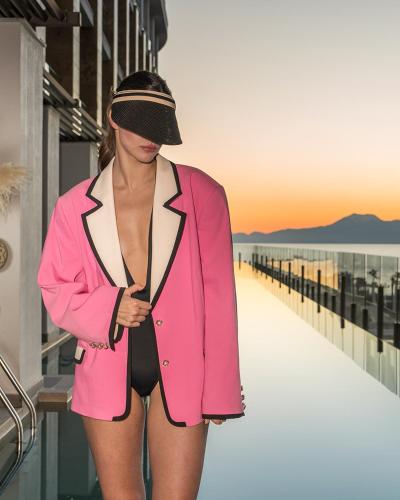 a woman in a pink jacket on the beach at Ethno Belek in Belek