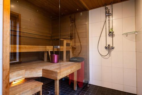 a sauna with a bench and a shower at Scandinavian summer cottage in Asikkala in Asikkala