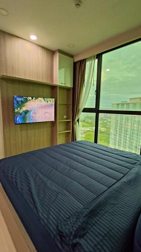 En eller flere senge i et værelse på Dusit Grand Condo View Jomtien By Snap Hosting