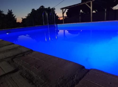 a swimming pool with blue illumination at night at La Casa de la Abuela 