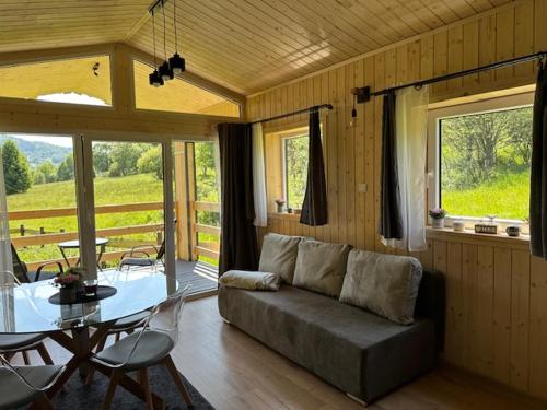 a living room with a couch and a table at Wichrowe Wzgórze 5 in Rajcza