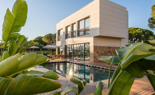 a house with a swimming pool in front of it at Ethno Belek in Belek
