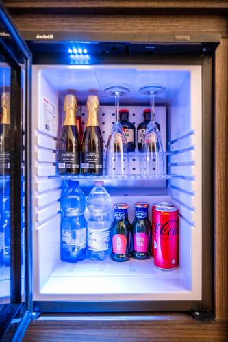a refrigerator filled with bottles and cans of drinks at Al Pellegrino - Albergo Ristorante Pizzeria in Gradisca dʼIsonzo
